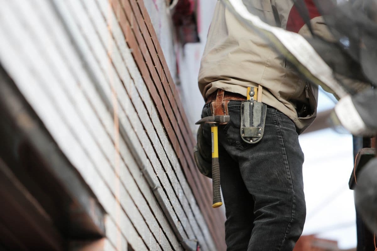 A tradesperson on the job with a tool belt
